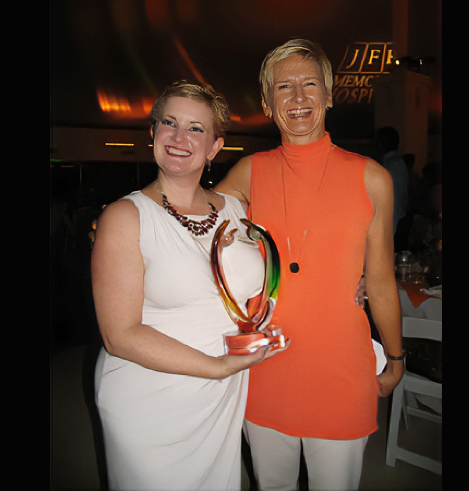 HARC CEO, Jenna LeComte-Hinely, holding an award